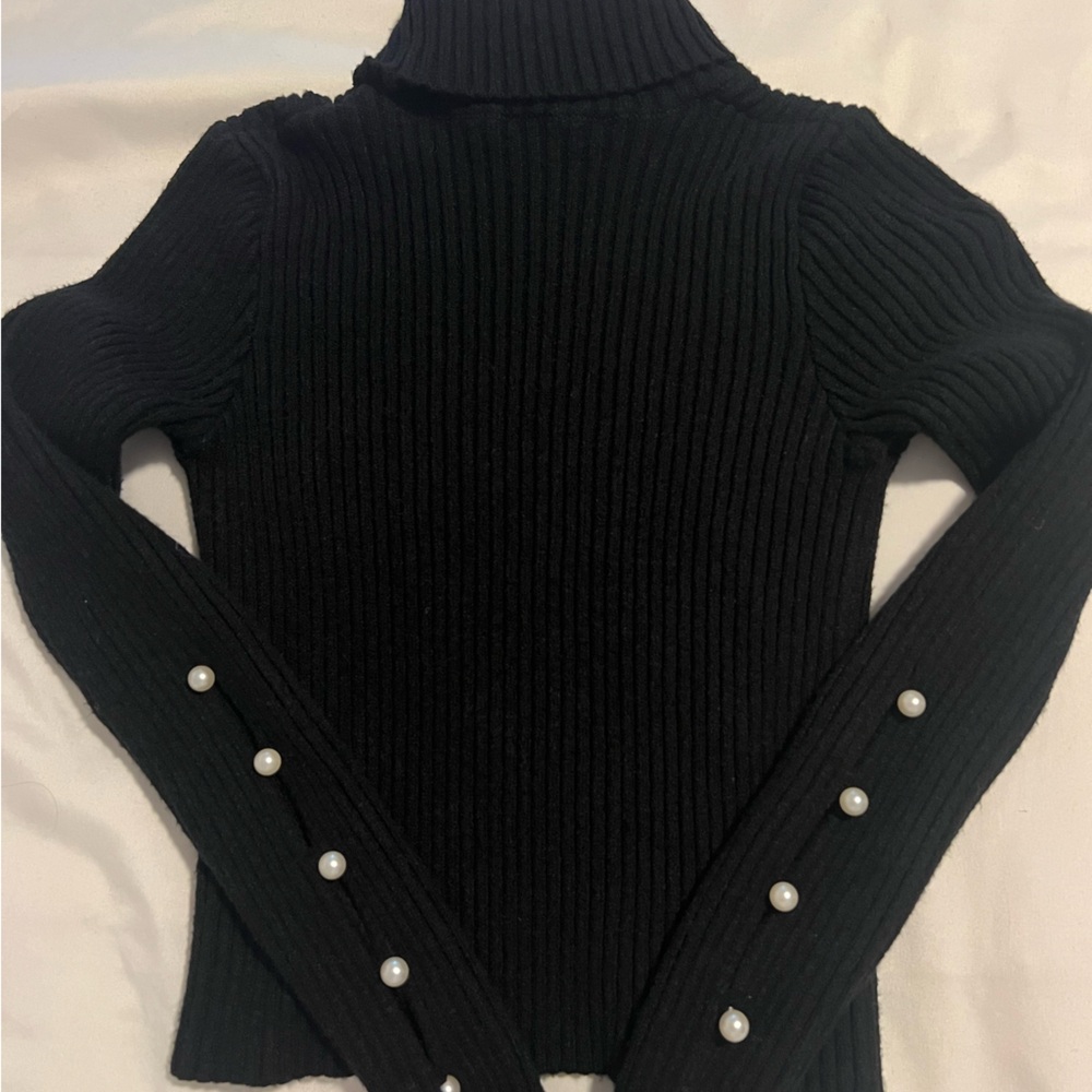 Knit turtleneck sweater with pearl sleeves